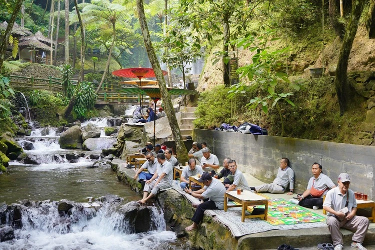 Corporate team gathering at an outdoor riverside venue
